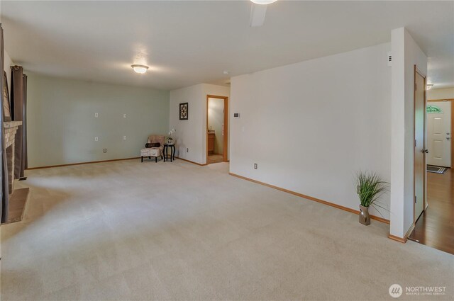 4101 Alabaster St SE, Lacey, WA 98503 - unfurnished living room featuring light colored carpet and a fireplace