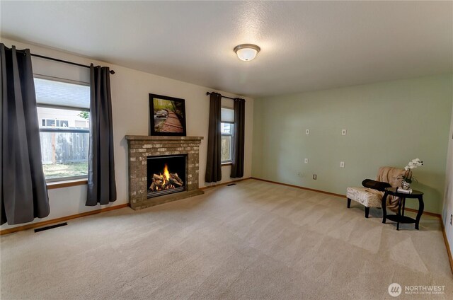 4101 Alabaster St SE, Lacey, WA 98503 - unfurnished living room featuring plenty of natural light, carpet floors, and a fireplace