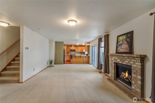 4101 Alabaster St SE, Lacey, WA 98503 - unfurnished living room with a fireplace, light carpet, stairway, and a textured ceiling