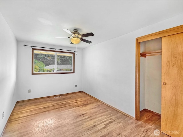 20219 7th Pl S, Des Moines, WA 98198 - unfurnished bedroom featuring wood finished floors, a closet, and ceiling fan