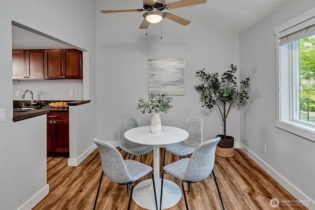 15819 NE Leary Way Unit D302, Redmond, WA 98052 - dining room featuring light wood finished floors, vaulted ceiling, and a ceiling fan