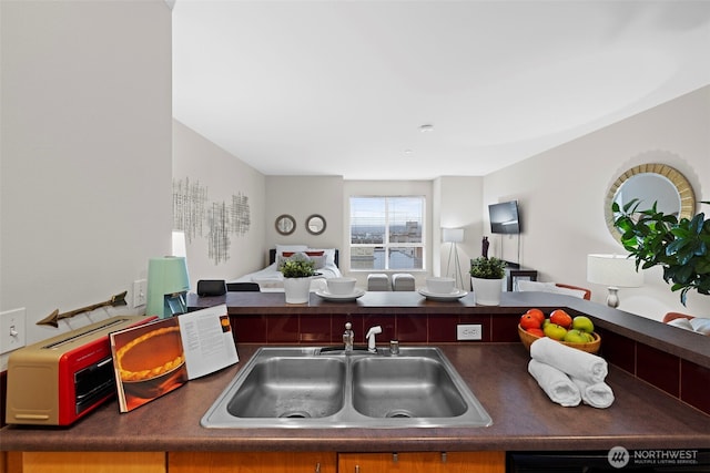 668 S Lane St Unit 603, Seattle, WA 98104 - kitchen with open floor plan, dark countertops, and dishwashing machine