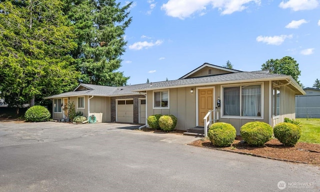 1202 Nelson St, Sedro Woolley, WA 98284 - view of front of home with a garage, board and batten siding, and asphalt driveway