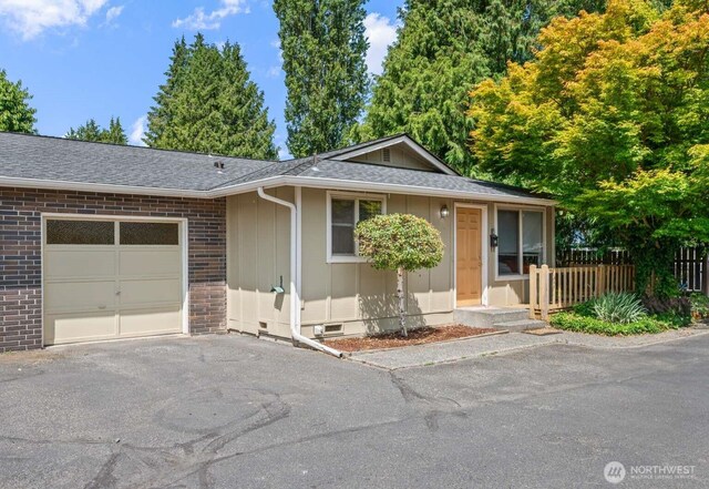 1202 Nelson St, Sedro Woolley, WA 98284 - ranch-style house with board and batten siding, brick siding, asphalt driveway, an attached garage, and roof with shingles