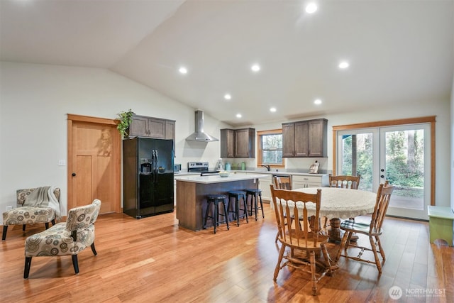 11211 Juniper Pl, Anderson Island, WA 98303 - dining space featuring lofted ceiling, french doors, light wood-type flooring, and recessed lighting