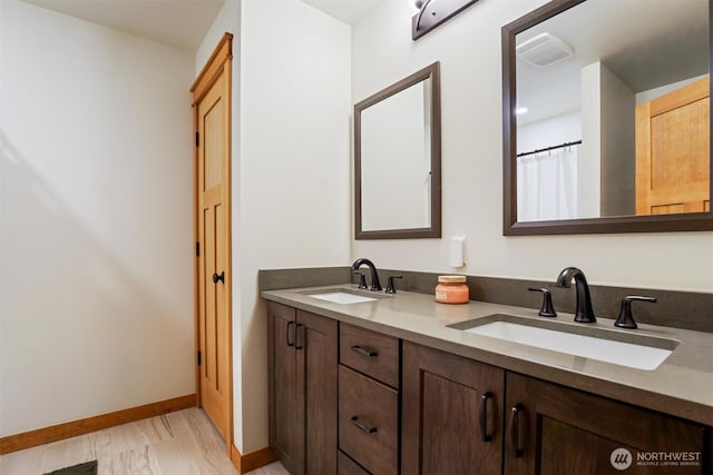 11211 Juniper Pl, Anderson Island, WA 98303 - bathroom featuring double vanity and marble finish flooring