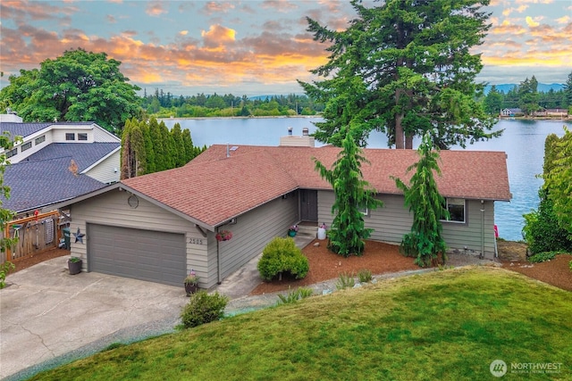 2505 211th Ave E, Lake Tapps, WA 98391 - view of front of house with a water view, a garage, a lawn, and driveway