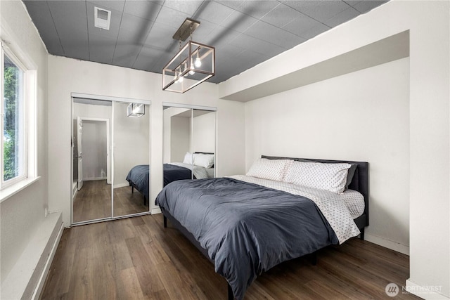 2505 211th Ave E, Lake Tapps, WA 98391 - bedroom featuring multiple closets, wood finished floors, and a chandelier
