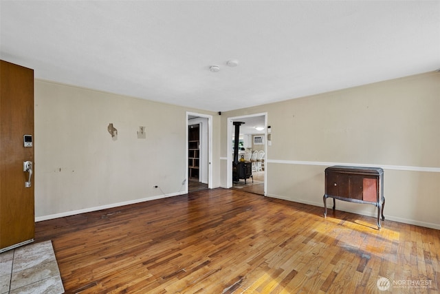 429 170th St S, Spanaway, WA 98387 - empty room with wood-type flooring, a wood stove, and a smoke detector