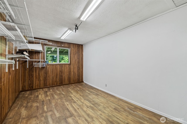 429 170th St S, Spanaway, WA 98387 - below grade area with a textured ceiling, wooden walls, and wood finished floors