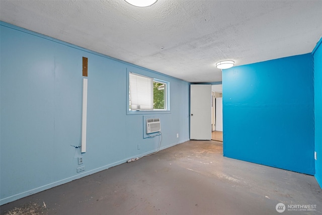 429 170th St S, Spanaway, WA 98387 - empty room with a textured ceiling, concrete flooring, and a wall unit AC