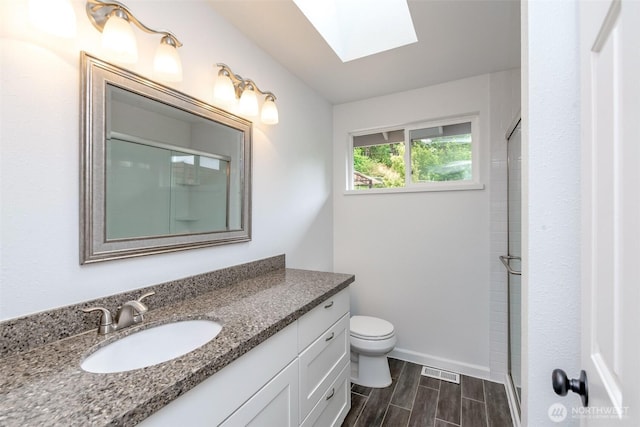 13457 SE Fairwood Blvd, Renton, WA 98058 - full bathroom with a skylight, vanity, wood finish floors, and an enclosed shower