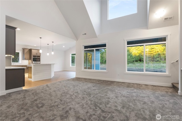 14317 Mima Rd SW, Olympia, WA 98512 - unfurnished living room featuring light colored carpet, vaulted ceiling, and recessed lighting