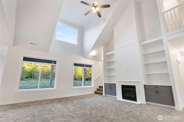 14317 Mima Rd SW, Olympia, WA 98512 - unfurnished living room with high vaulted ceiling, carpet, stairs, healthy amount of natural light, and a ceiling fan