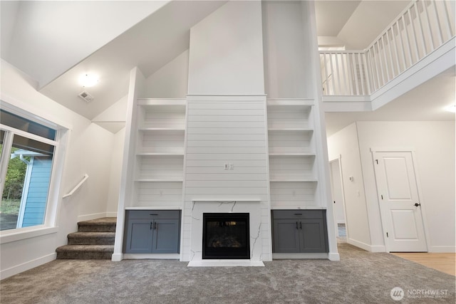 14317 Mima Rd SW, Olympia, WA 98512 - unfurnished living room featuring carpet floors, stairway, a premium fireplace, and high vaulted ceiling