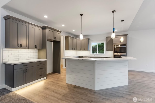 14317 Mima Rd SW, Olympia, WA 98512 - kitchen with double oven, decorative backsplash, light wood-style floors, a center island, and recessed lighting