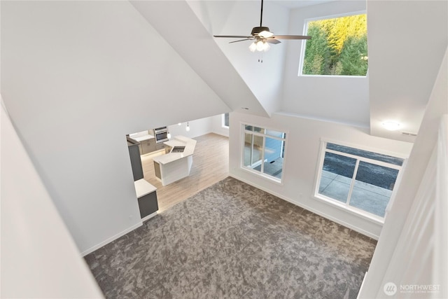 14317 Mima Rd SW, Olympia, WA 98512 - unfurnished living room with carpet floors, a ceiling fan, and a high ceiling