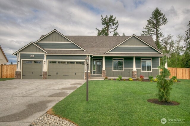 14317 Mima Rd SW, Olympia, WA 98512 - craftsman-style house with an attached garage, concrete driveway, a porch, roof with shingles, and board and batten siding