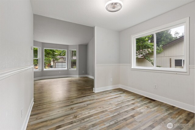 22415 Bluewater Dr SE, Yelm, WA 98597 - spare room with healthy amount of natural light and wood finished floors