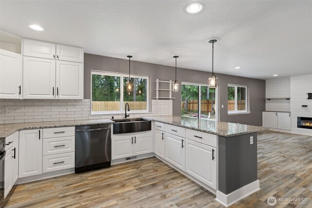 22415 Bluewater Dr SE, Yelm, WA 98597 - kitchen with dishwasher, a peninsula, healthy amount of natural light, light wood-type flooring, and recessed lighting