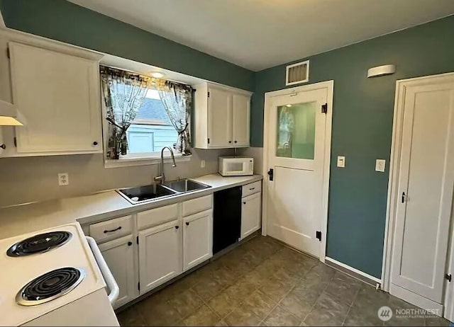 302 S Albert St, Port Angeles, WA 98362 - kitchen with white cabinetry, white microwave, light countertops, and stove
