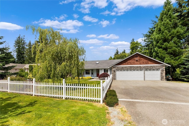 8615 176th St NW, Stanwood, WA 98282 - view of front of home with driveway, a garage, and stone siding