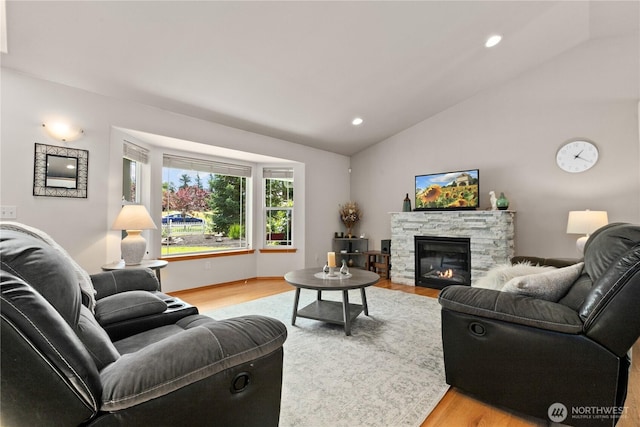 8615 176th St NW, Stanwood, WA 98282 - living room with light wood finished floors, lofted ceiling, a stone fireplace, and recessed lighting