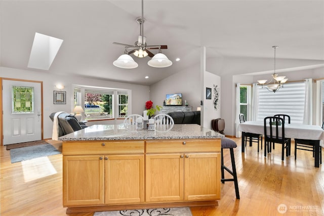 8615 176th St NW, Stanwood, WA 98282 - kitchen featuring open floor plan, vaulted ceiling, light wood-style flooring, and healthy amount of natural light