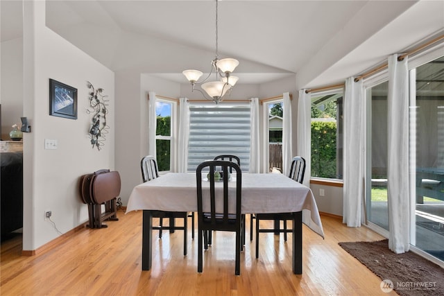 8615 176th St NW, Stanwood, WA 98282 - dining space with lofted ceiling, light wood-type flooring, and a chandelier