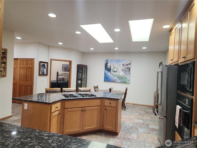 16314 2nd Dr SE, Bothell, WA 98012 - kitchen with black appliances, recessed lighting, a kitchen island, dark stone counters, and a skylight