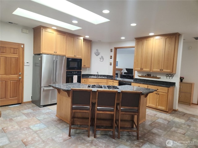 16314 2nd Dr SE, Bothell, WA 98012 - kitchen with black appliances, a kitchen bar, recessed lighting, a center island, and a skylight