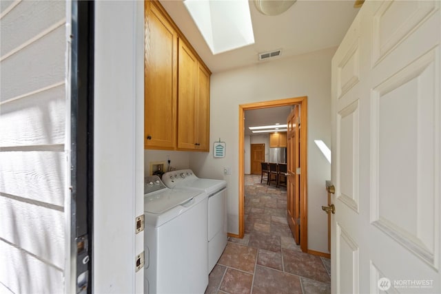 16314 2nd Dr SE, Bothell, WA 98012 - washroom featuring cabinet space, separate washer and dryer, stone finish flooring, and a skylight