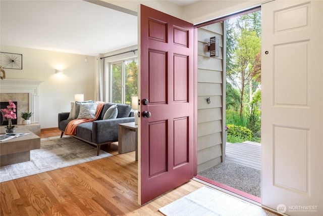 822 206th Ave NE, Sammamish, WA 98074 - entrance foyer with light wood-style flooring and a high end fireplace