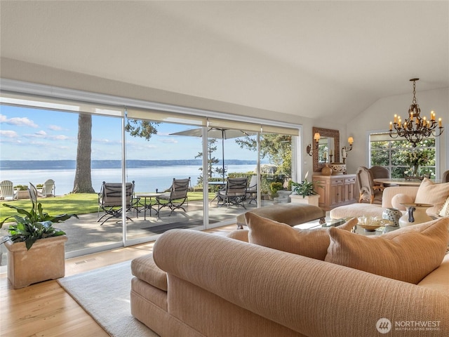 19263 Edgecliff Dr SW, Normandy Park, WA 98166 - living room with a chandelier, a water view, light wood-style flooring, and vaulted ceiling