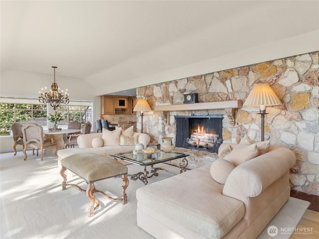 19263 Edgecliff Dr SW, Normandy Park, WA 98166 - living area with a chandelier, a stone fireplace, and vaulted ceiling