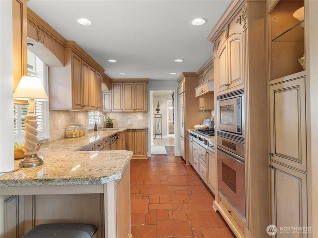 19263 Edgecliff Dr SW, Normandy Park, WA 98166 - kitchen with appliances with stainless steel finishes, decorative backsplash, a peninsula, light stone countertops, and recessed lighting