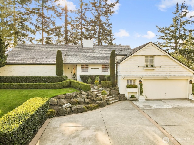 19263 Edgecliff Dr SW, Normandy Park, WA 98166 - view of front of home featuring a chimney, concrete driveway, stucco siding, and a front yard