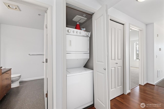 124 Bellevue Ave E Unit 504, Seattle, WA 98102 - washroom with stacked washing machine and dryer and wood finished floors
