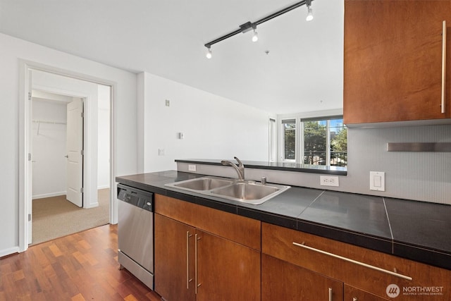 124 Bellevue Ave E Unit 504, Seattle, WA 98102 - kitchen with dishwasher, dark wood-type flooring, rail lighting, brown cabinetry, and a peninsula