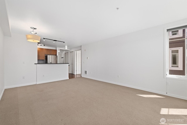 124 Bellevue Ave E Unit 504, Seattle, WA 98102 - unfurnished living room with track lighting and light colored carpet