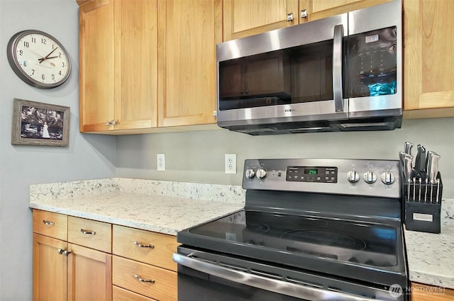 132 Tanglewood Dr, Longview, WA 98632 - kitchen featuring range with electric stovetop, stainless steel microwave, and light stone counters
