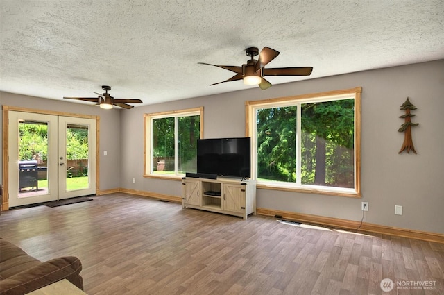 132 Tanglewood Dr, Longview, WA 98632 - unfurnished living room featuring ceiling fan, wood finished floors, a textured ceiling, and french doors