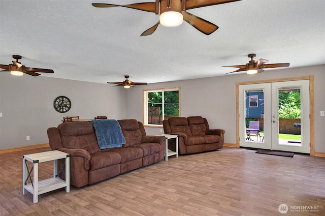132 Tanglewood Dr, Longview, WA 98632 - living area featuring ceiling fan, light wood-style flooring, a textured ceiling, and french doors