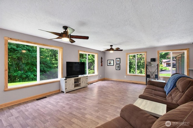 132 Tanglewood Dr, Longview, WA 98632 - living area with wood finished floors, plenty of natural light, ceiling fan, and a textured ceiling