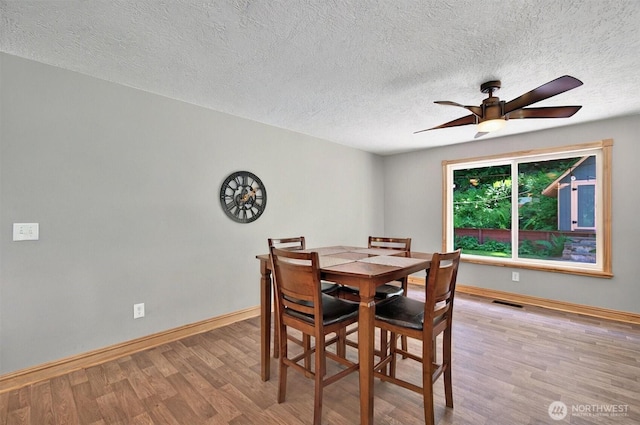 132 Tanglewood Dr, Longview, WA 98632 - dining area with wood finished floors, ceiling fan, and a textured ceiling