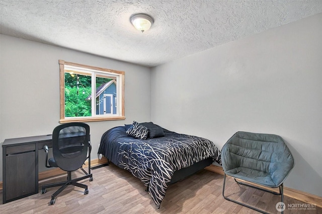 132 Tanglewood Dr, Longview, WA 98632 - bedroom with wood finished floors, a textured ceiling, and an office area