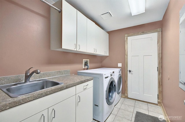 132 Tanglewood Dr, Longview, WA 98632 - laundry area featuring cabinet space, washer and dryer, and light tile patterned floors