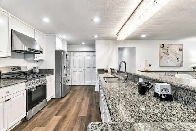 20 Cascade Ky, Bellevue, WA 98006 - kitchen with appliances with stainless steel finishes, wall chimney exhaust hood, a textured ceiling, dark stone counters, and white cabinetry