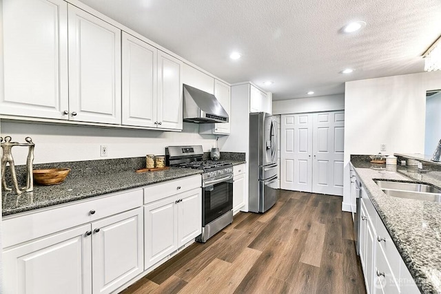 20 Cascade Ky, Bellevue, WA 98006 - kitchen featuring stainless steel appliances, wall chimney range hood, a textured ceiling, white cabinets, and recessed lighting