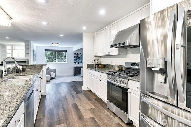 20 Cascade Ky, Bellevue, WA 98006 - kitchen with appliances with stainless steel finishes, wall chimney range hood, white cabinets, recessed lighting, and stone counters